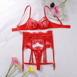 Three-piece sheer red lingerie set with underwire bra, lace garter belt and thong on a white background