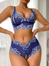 Close-up of blue lace lingerie set with floral design and satin bows