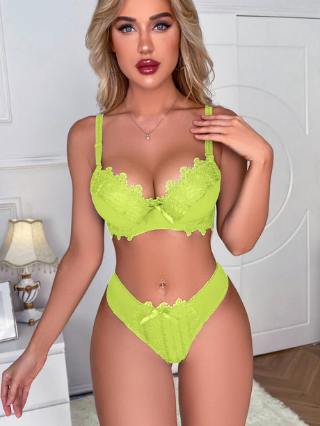 Lime green lingerie set with model adjusting straps in frontal pose