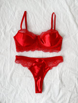 Top view of a red satin lingerie set with lace details.